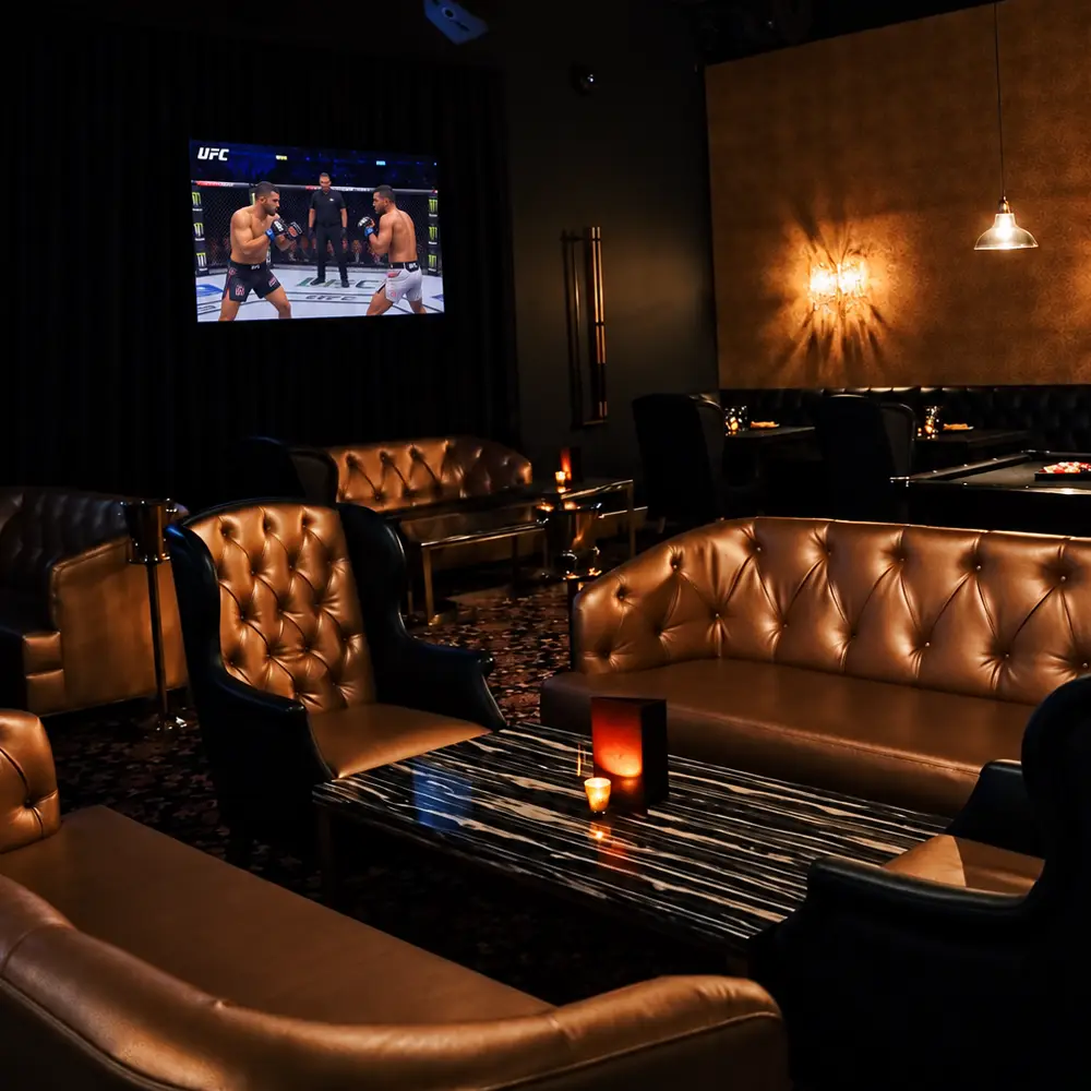 Plush lounge seating and sports viewing at Rick’s Steakhouse & Lounge